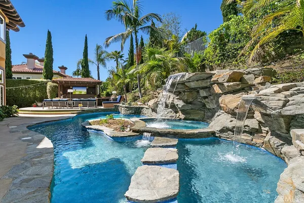 a view of a swimming pool with a table and chairs