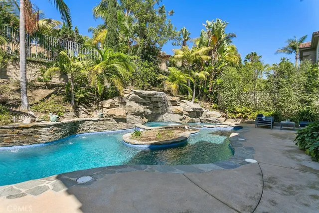 a view of a house with swimming pool and sitting area