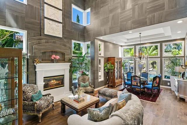 a living room with furniture fireplace and floor to ceiling windows