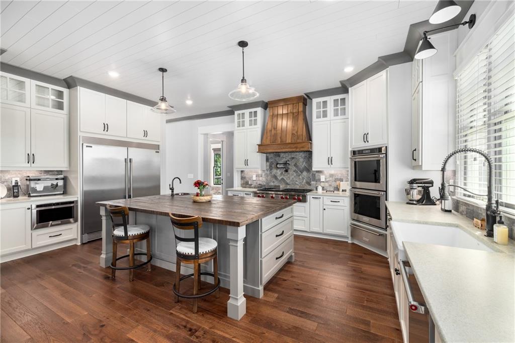 938 Austin Road Winder, GA 30680 - Photo 14 of 50 a kitchen with stainless steel appliances granite countertop a stove refrigerator and a sink