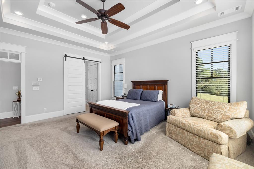 938 Austin Road Winder, GA 30680 - Photo 18 of 50 a spacious bedroom with a bed furniture and a window