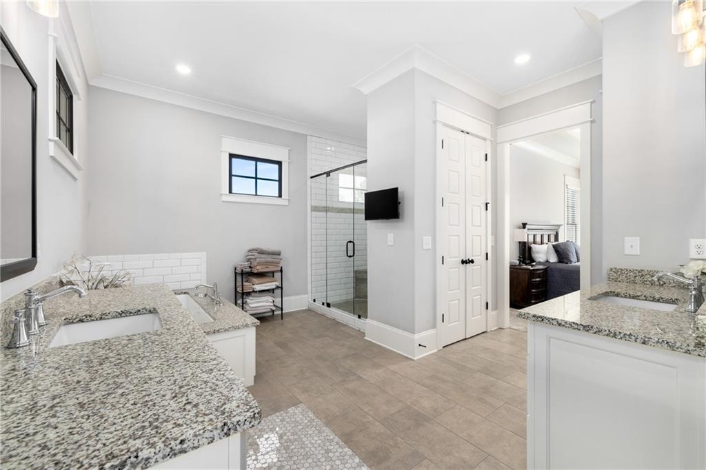 938 Austin Road Winder, GA 30680 - Photo 19 of 50 a spacious bedroom with a large bed and a couch