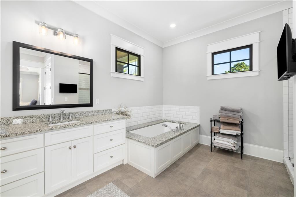 938 Austin Road Winder, GA 30680 - Photo 21 of 50 a bathroom with a tub sink and mirror