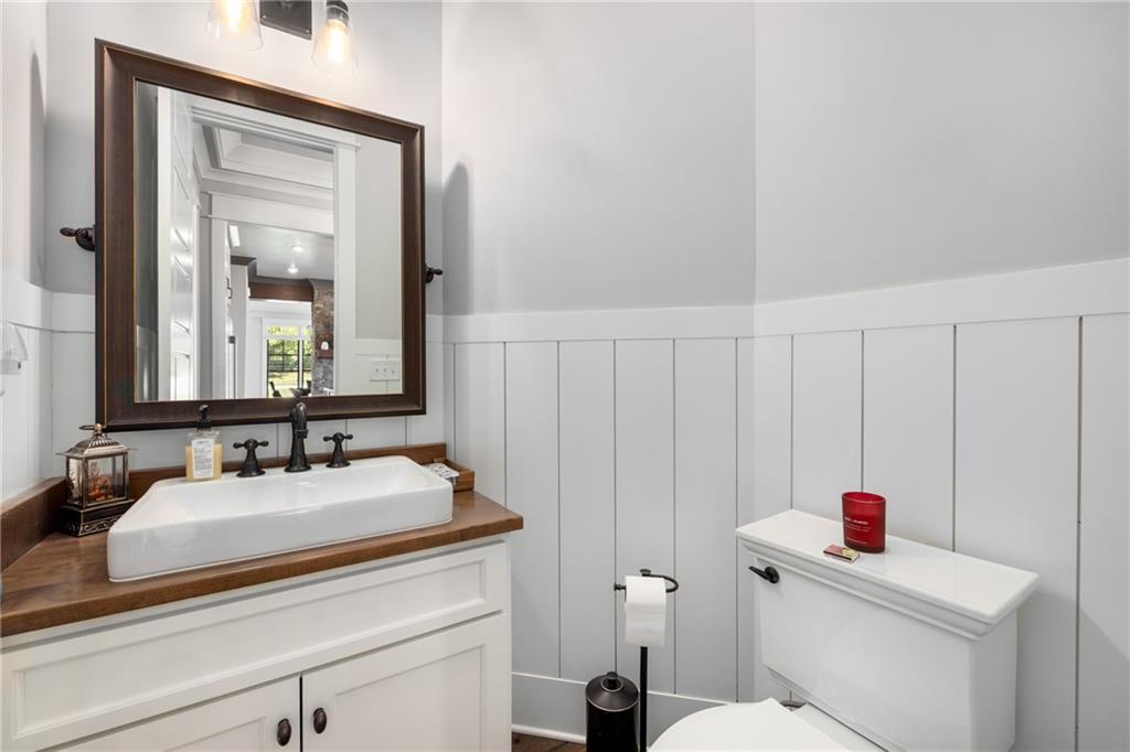 938 Austin Road Winder, GA 30680 - Photo 24 of 50 a bathroom with a sink vanity mirror and toilet