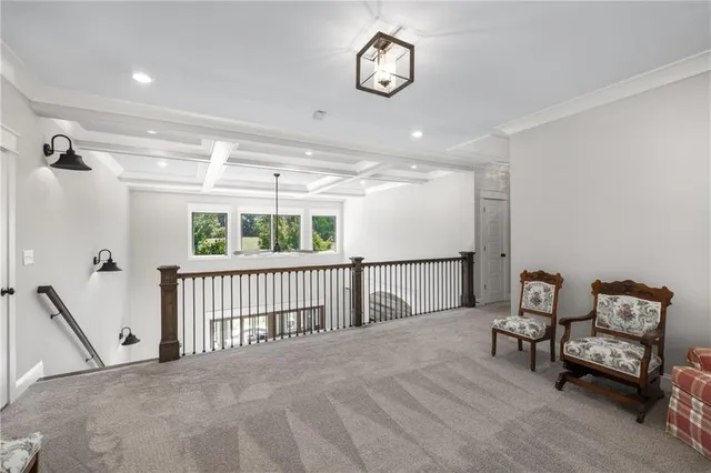 a view of a livingroom with wooden floor and a ceiling fan