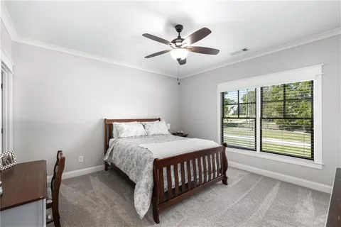 a spacious bedroom with a bed and window