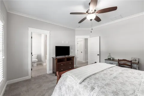 a bathroom with a granite countertop toilet a sink a mirror and a shower