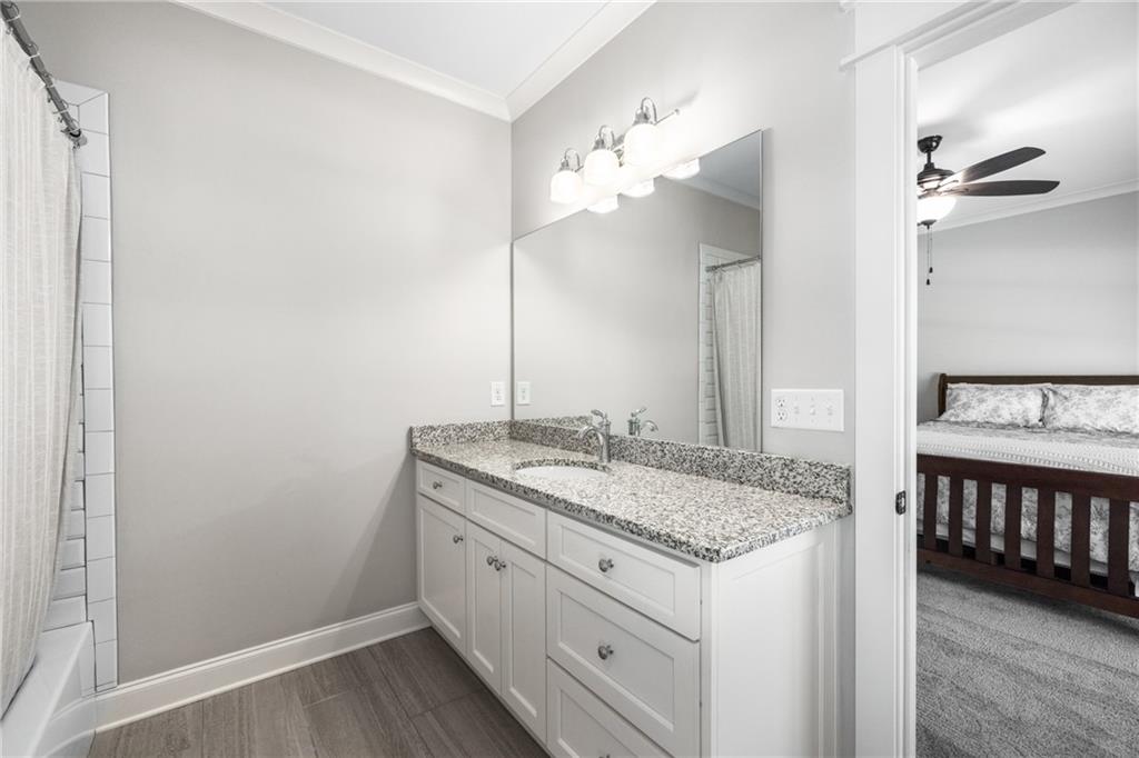 938 Austin Road Winder, GA 30680 - Photo 30 of 50 a bathroom with a granite countertop sink and a mirror
