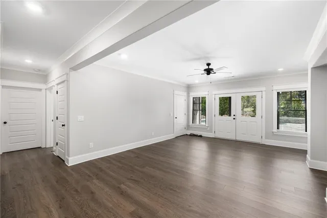 a view of a house with a big yard and large trees