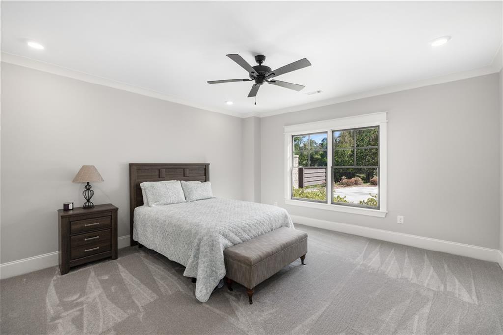 938 Austin Road Winder, GA 30680 - Photo 36 of 50 a spacious bedroom with a bed and window