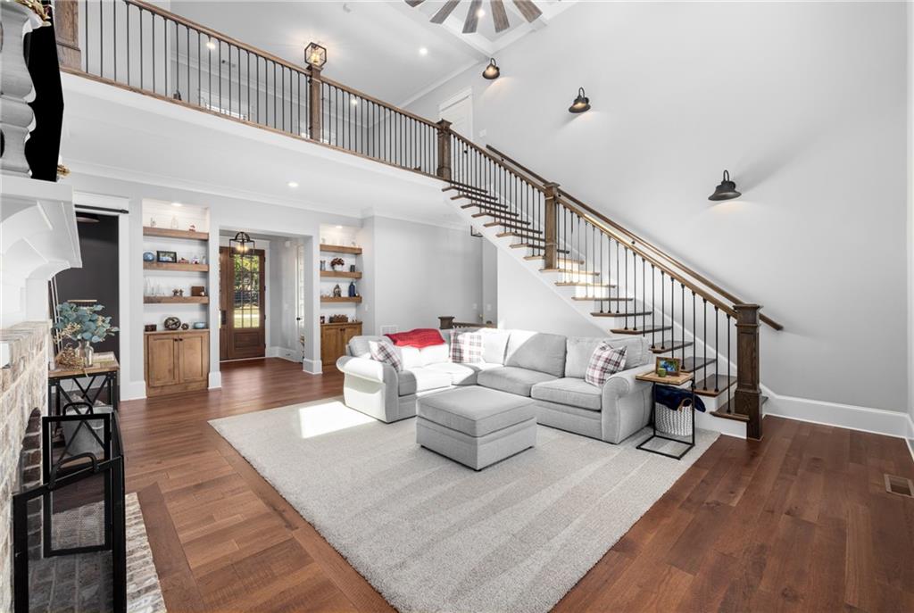 938 Austin Road Winder, GA 30680 - Photo 8 of 50 a living room with furniture or stairs and a wooden floor