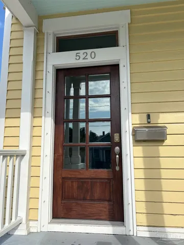a kitchen with granite countertop a sink and white cabinets with wooden floor
