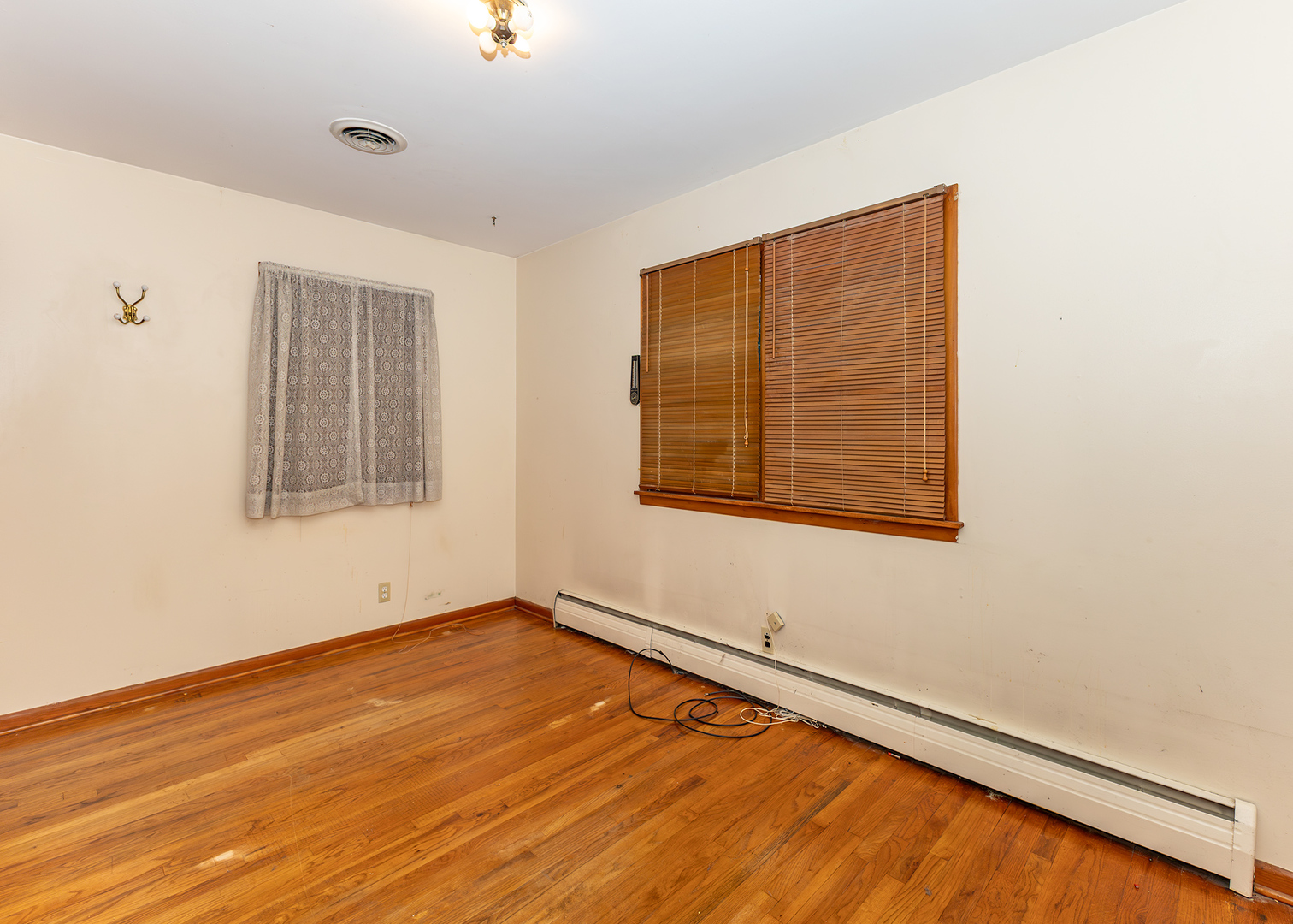 1608 3rd Street Camanche, IA 52730 - Photo 15 of 25 an empty room with wooden floor and windows