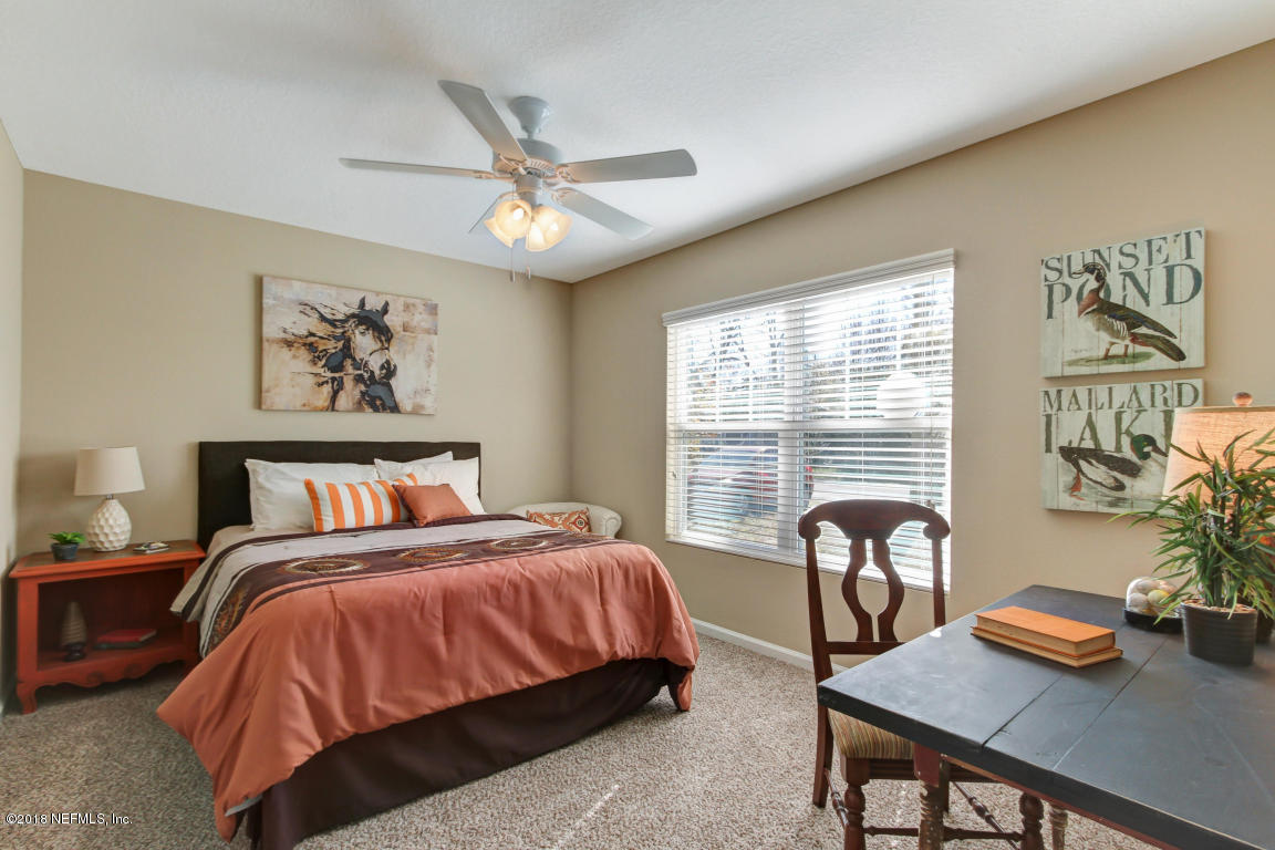 2937 Kent Road Jacksonville, FL 32216 - Photo 3 of 22 a bedroom with a bed and a table with chair