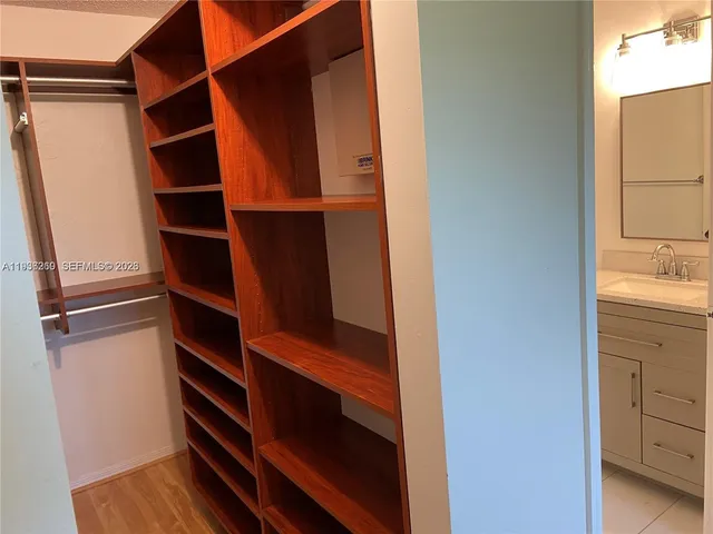 a view of walk in closet with empty racks