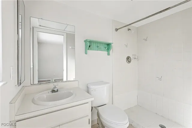 a bathroom with a bathtub shower sink vanity and toilet