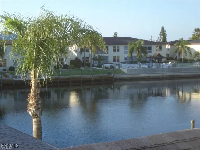 a view of residential houses with outdoor space and lake view