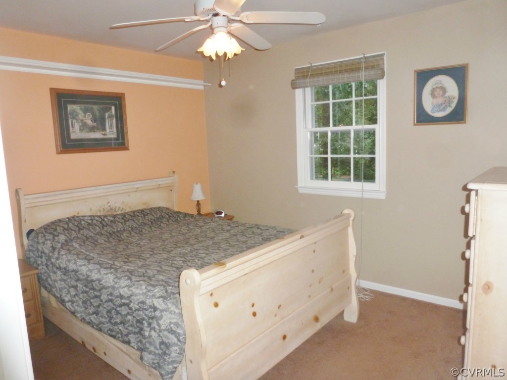 3600 Hemlock Road Chester, VA 23831 - Photo 12 of 24 a bedroom with a bed and a chandelier