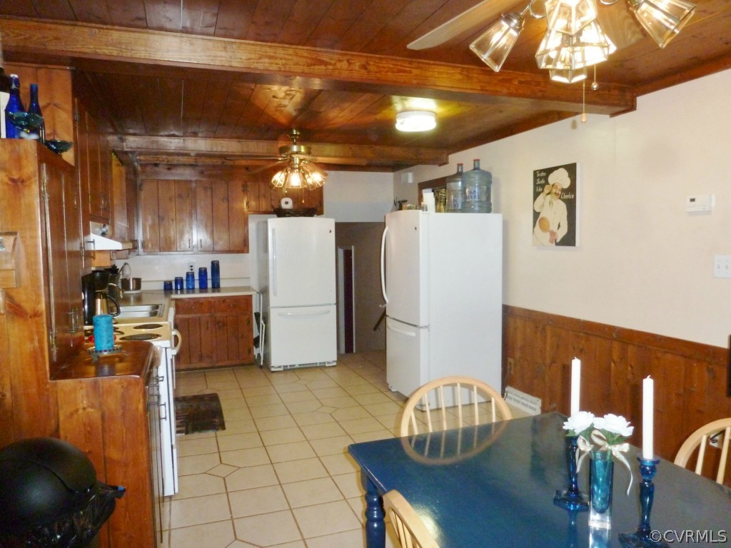 3600 Hemlock Road Chester, VA 23831 - Photo 6 of 24 a kitchen with a refrigerator a stove and a dining table with wooden floor