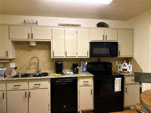 a view of a room with gym equipment and wooden floor