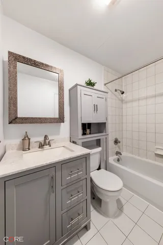 a bedroom with a bed and a flat tv screen on the dresser