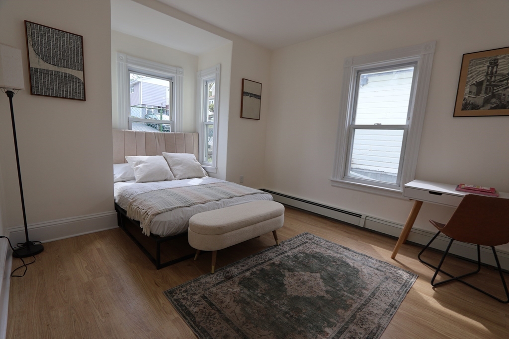 331 Proctor Avenue Revere, MA 02151 - Photo 13 of 29 a bedroom with a bed chair and two windows