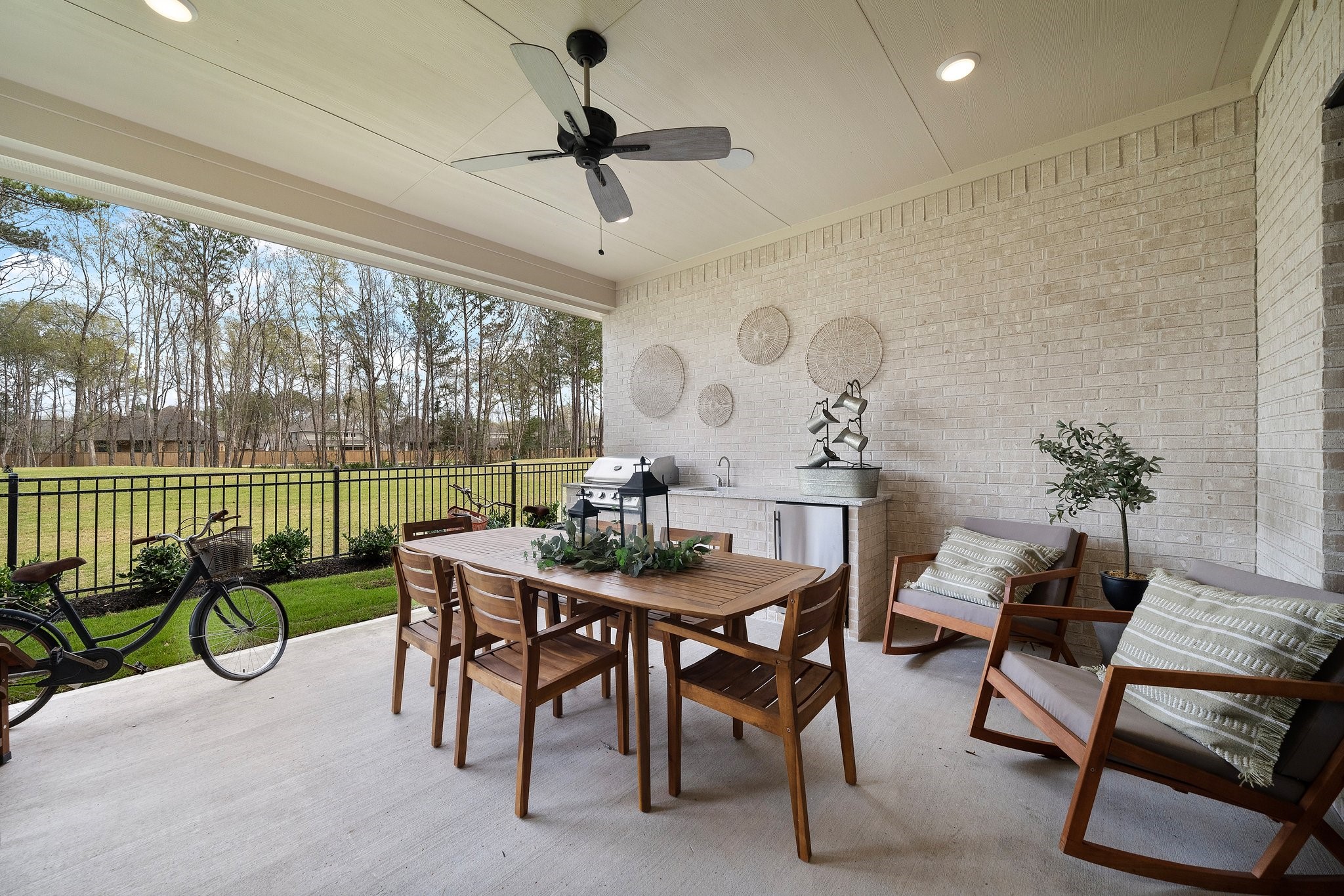 21702 Leaton Circle Porter, TX 77365 - Photo 28 of 36 Covered outdoor living with built-in grill and seating area, overlooking the backyard with beautiful golf course views—perfect for relaxing or entertaining.