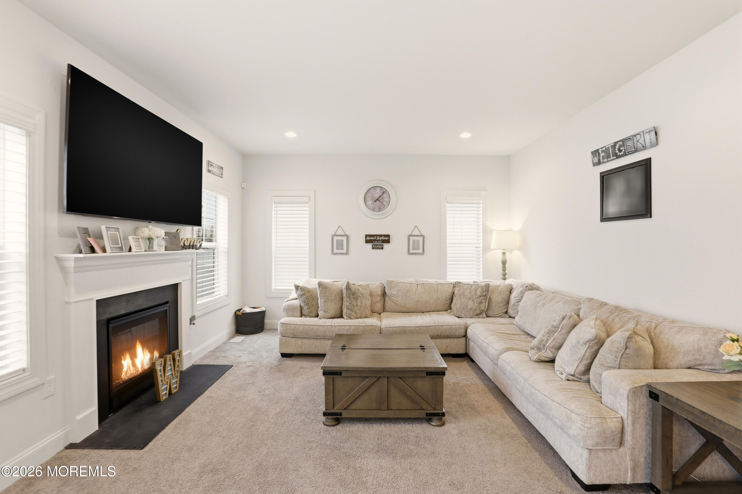 4 Tasha Lane Howell, NJ 07731 - Photo 13 of 55 a living room with furniture a fireplace and a flat screen tv