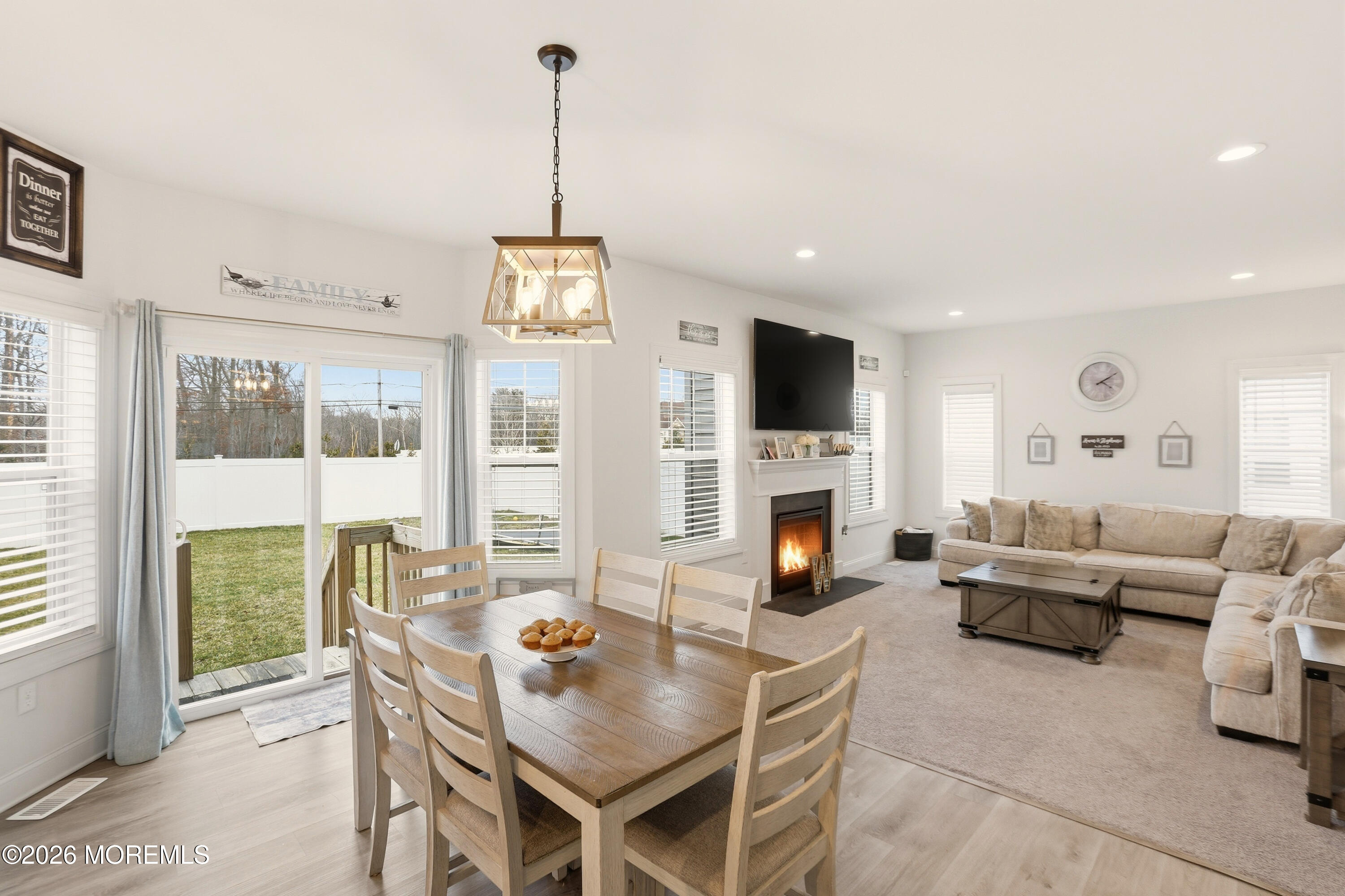 4 Tasha Lane Howell, NJ 07731 - Photo 19 of 55 a living room with furniture a fireplace and a floor to ceiling window