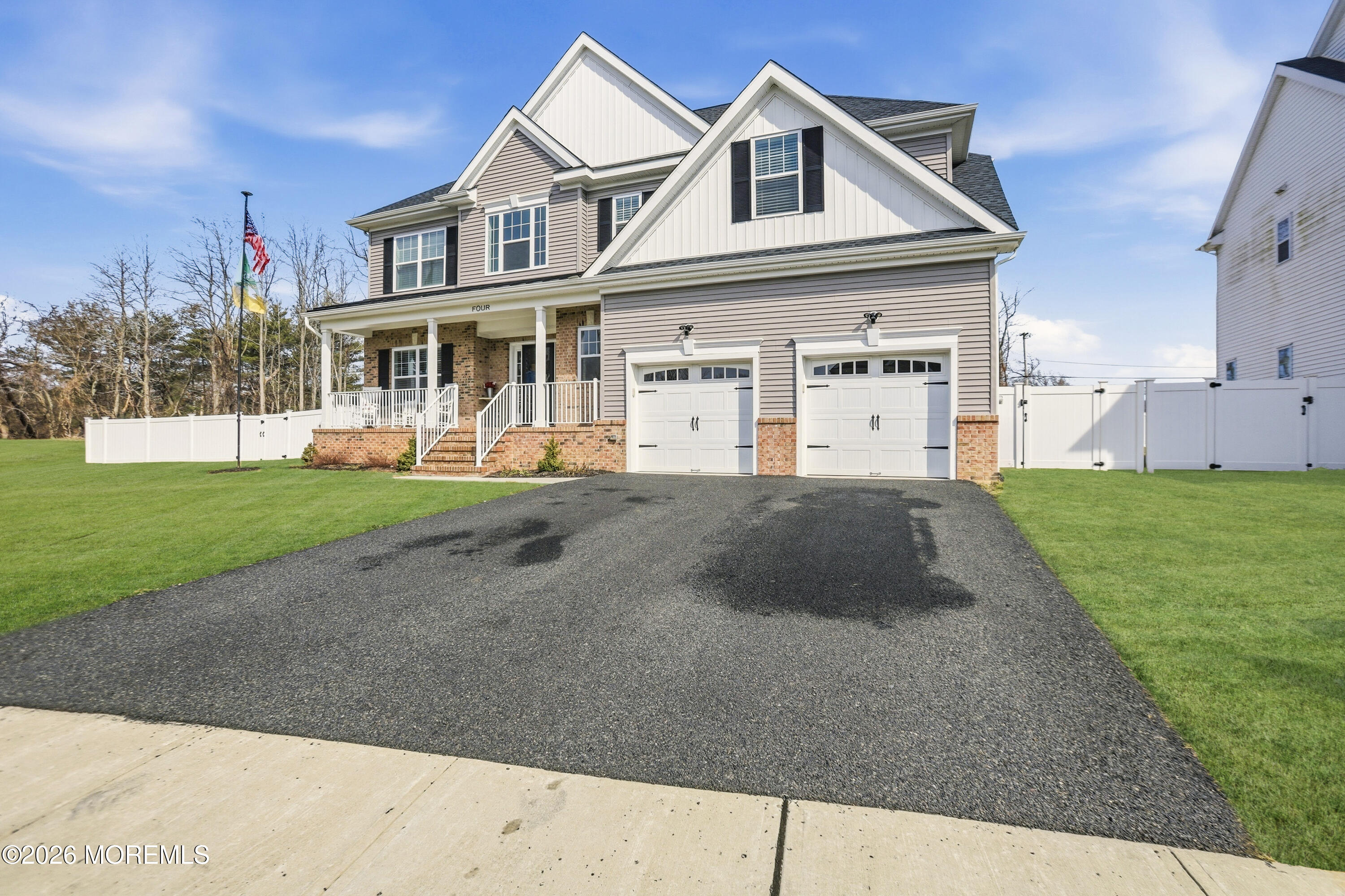 4 Tasha Lane Howell, NJ 07731 - Photo 2 of 55 a front view of a house with a yard and garage