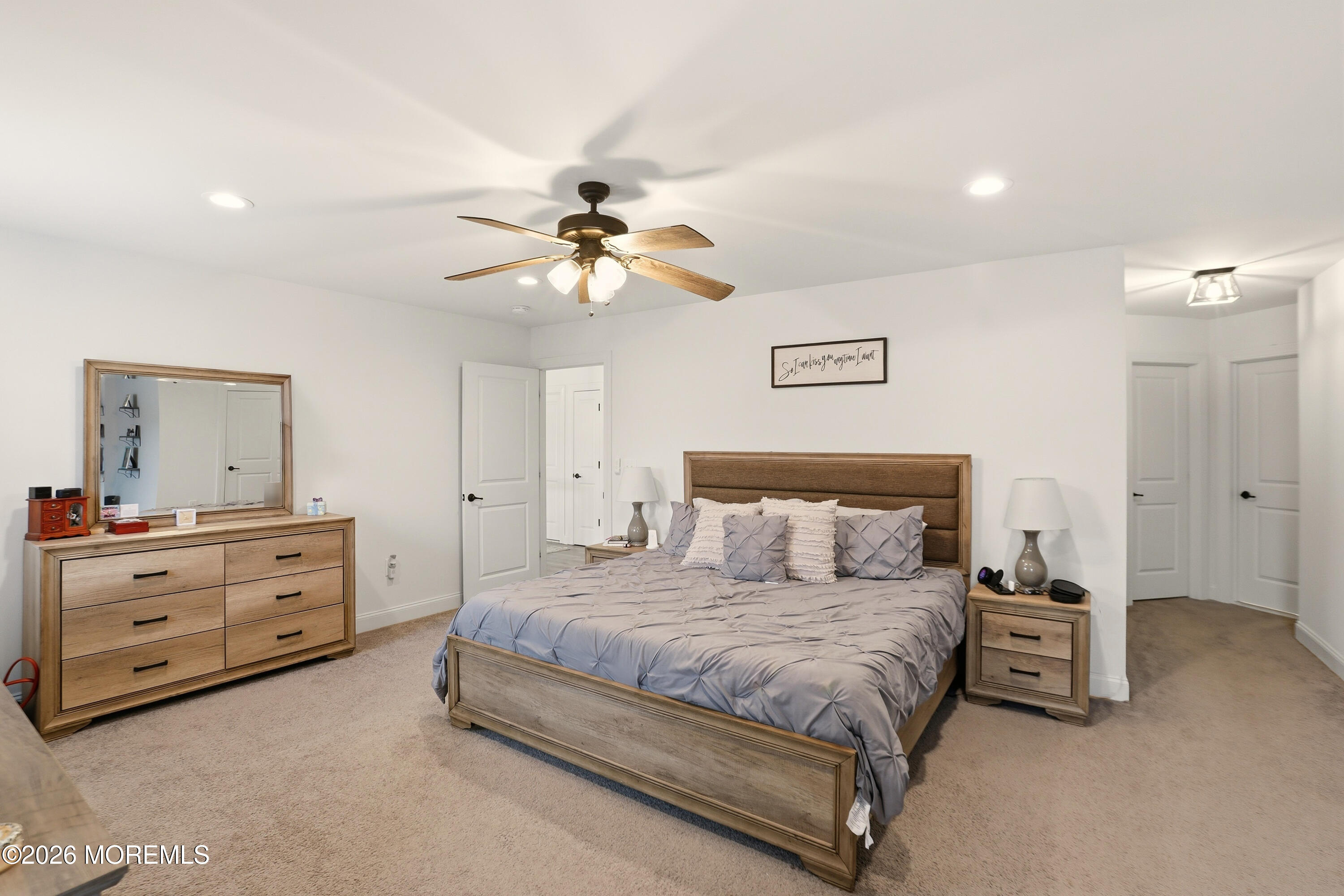 4 Tasha Lane Howell, NJ 07731 - Photo 31 of 55 a spacious bedroom with a bed and a chandelier