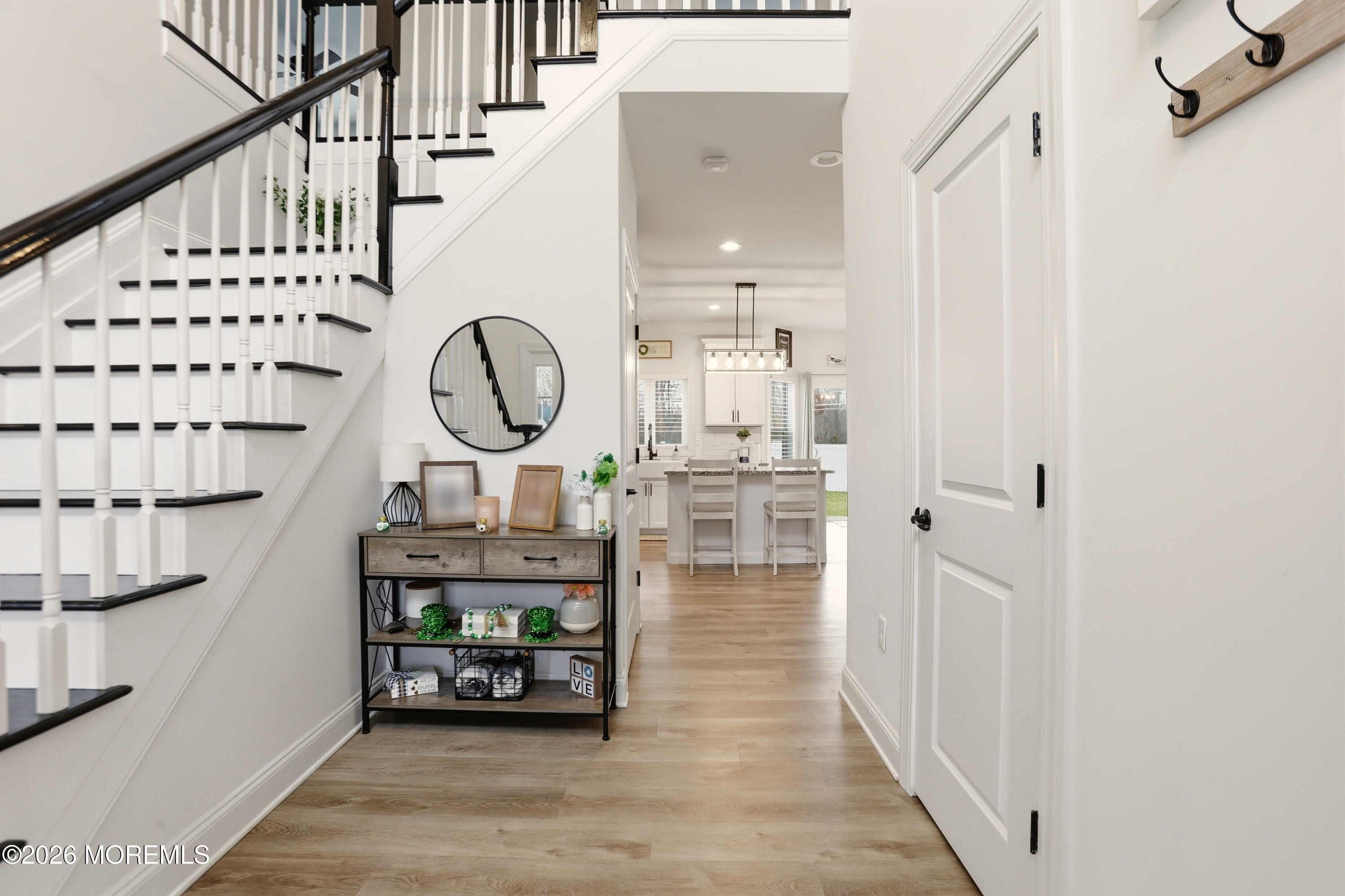 4 Tasha Lane Howell, NJ 07731 - Photo 8 of 55 a view of a hallway with wooden floor and staircase
