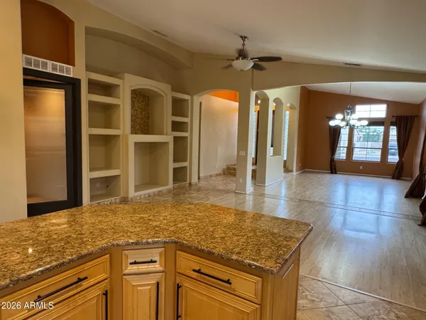 a kitchen with granite countertop a sink and cabinets