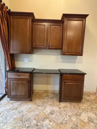 a view of kitchen with granite countertop cabinets and black the top oven