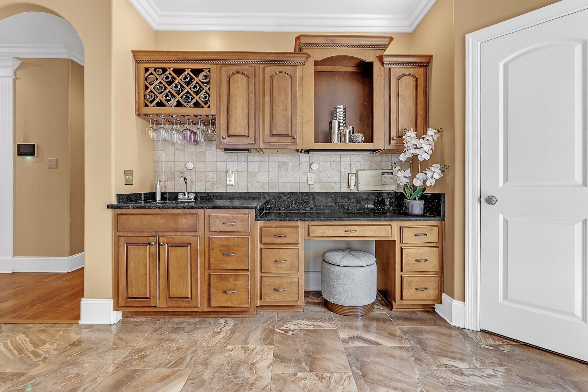 649 Ridge Springs Road Collierville, TN 38017 - Photo 13 of 38 Wet bar featuring wood cabinetry, a built-in wine rack, and stemware storage