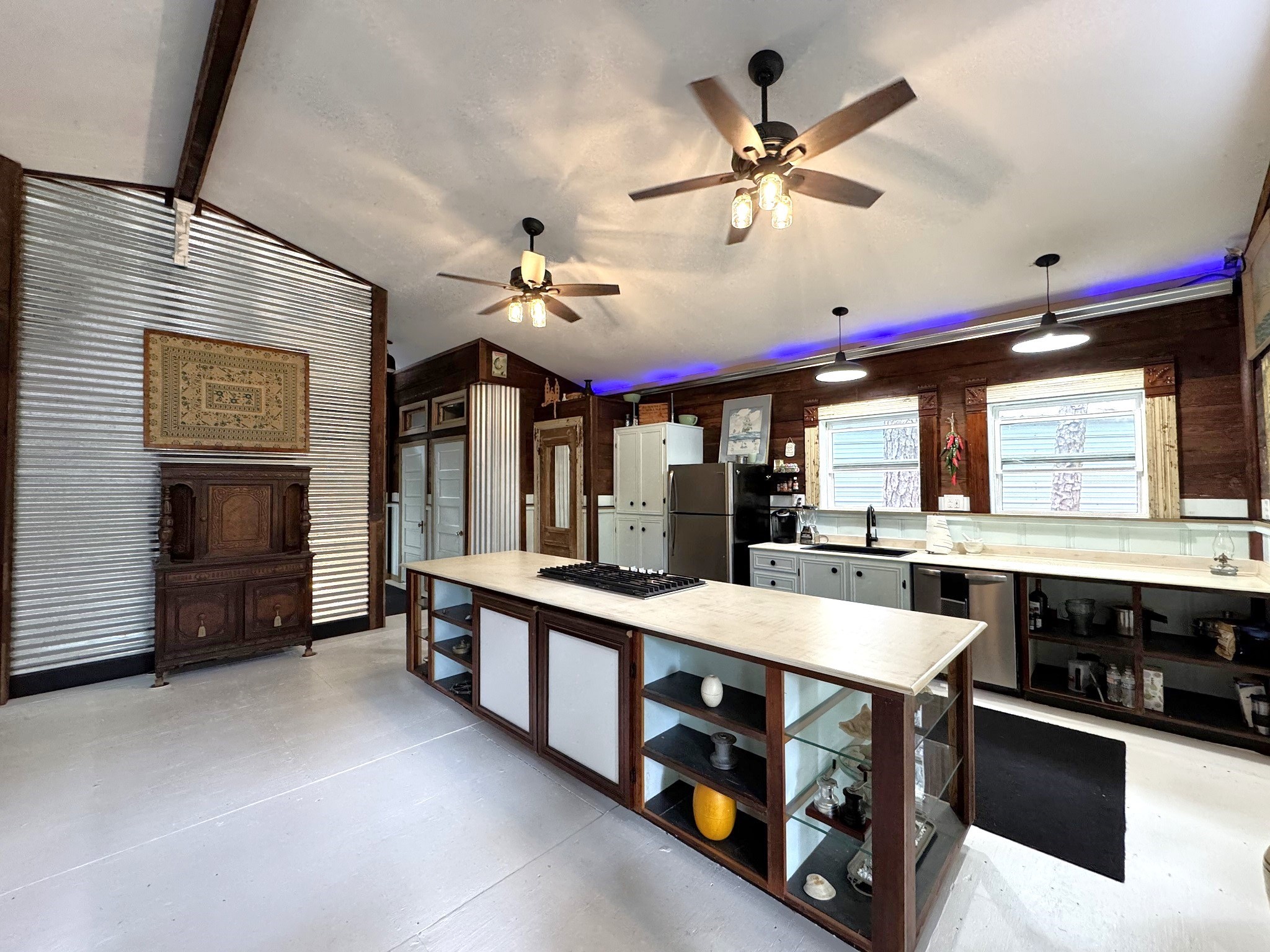 331 County Road 3240 Colmesneil, TX 75938 - Photo 13 of 50 a large kitchen with stainless steel appliances a stove a chimney a sink and a large window