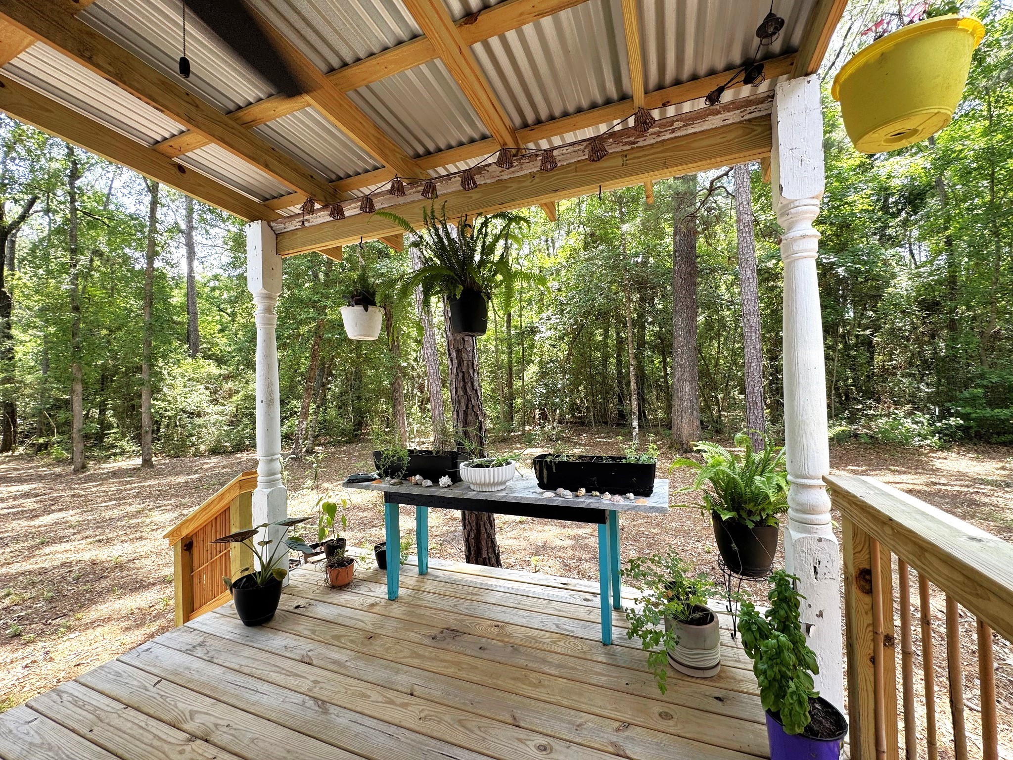 331 County Road 3240 Colmesneil, TX 75938 - Photo 27 of 50 a view of a chairs and table in patio with wooden floor