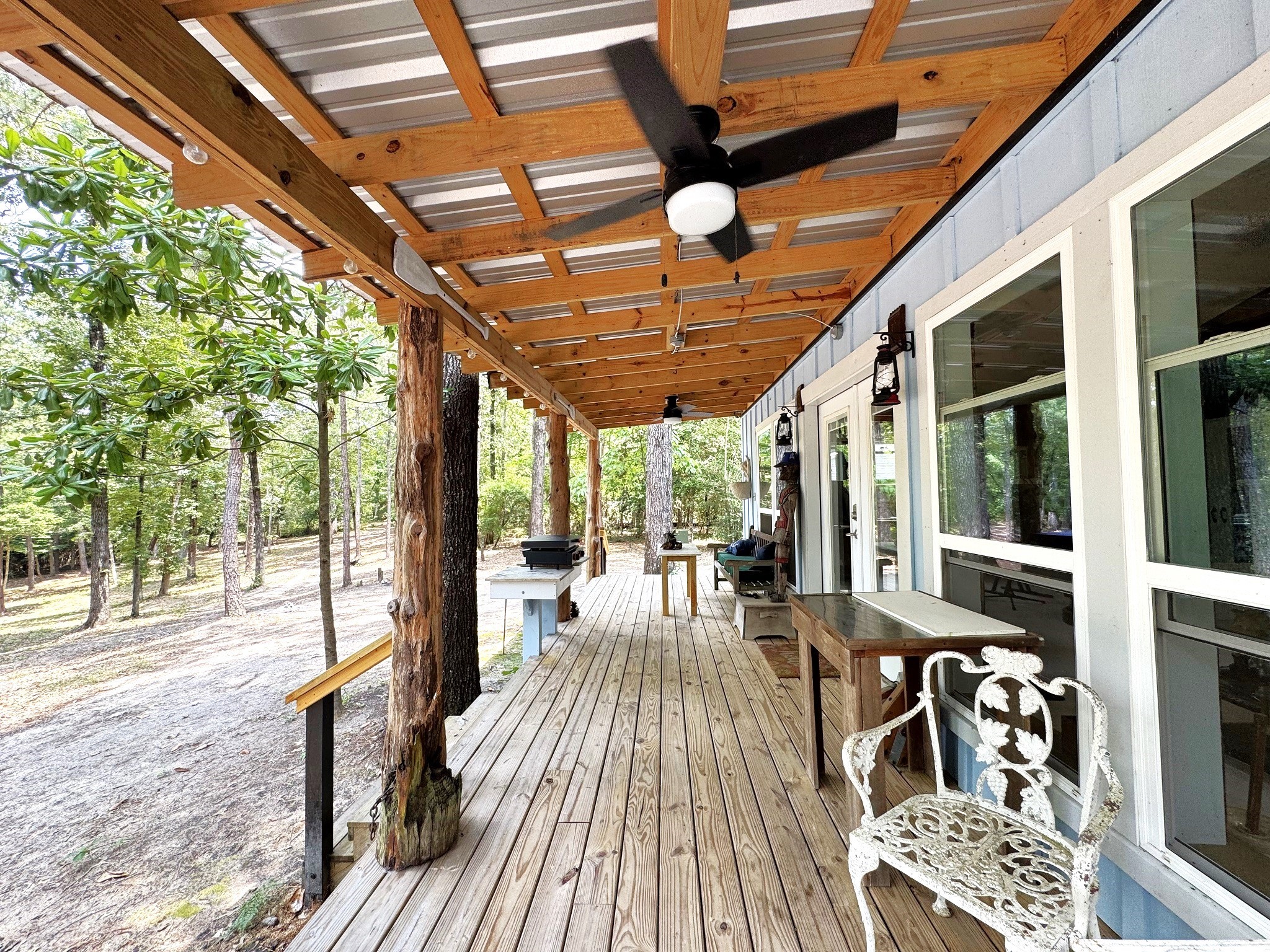 331 County Road 3240 Colmesneil, TX 75938 - Photo 7 of 50 a view of a patio with table and chairs and wooden floor