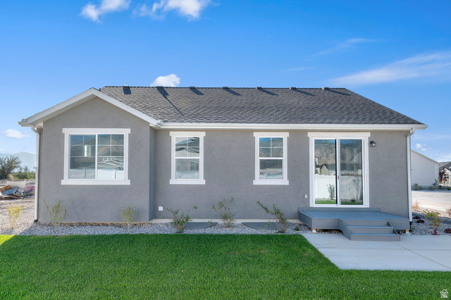 5644 Ibis Road Tooele, UT 84074 - Photo 5 of 19 Rear exterior featuring a gray stucco finish and a dark shingle roof