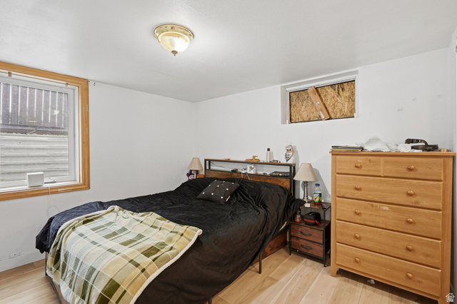 707 East 150 South Provo, UT 84606 - Photo 24 of 31 Bedroom #5 Room featuring light wood-finish flooring, white painted walls, and a ceiling-mounted light fixture