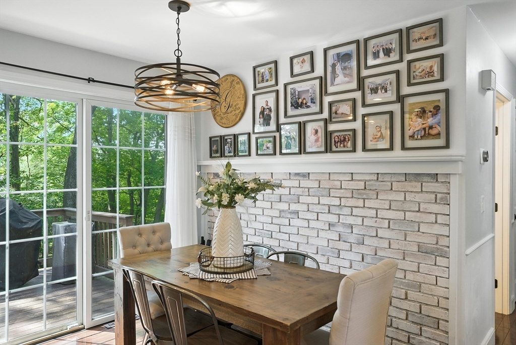 22 Dean Street Hudson, MA 01749 - Photo 12 of 30 a front view of a dining room with furniture wooden floor and chandelier