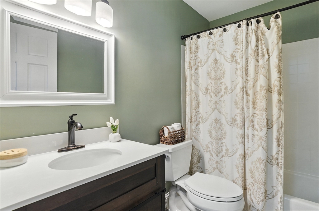 22 Dean Street Hudson, MA 01749 - Photo 21 of 30 a bathroom with a sink a toilet and shower curtain