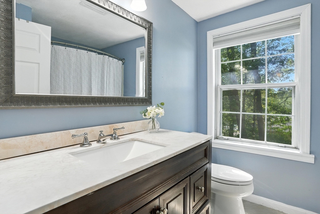 22 Dean Street Hudson, MA 01749 - Photo 22 of 30 a bathroom with a sink a toilet and a window