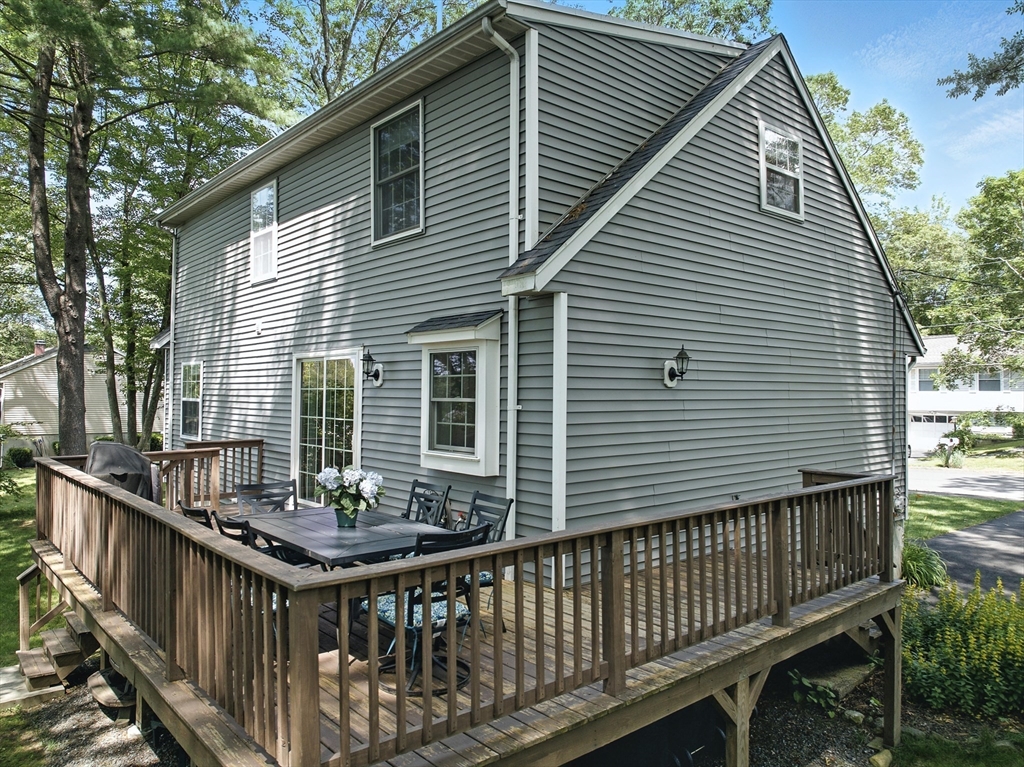22 Dean Street Hudson, MA 01749 - Photo 25 of 30 a view of a house with wooden deck and furniture