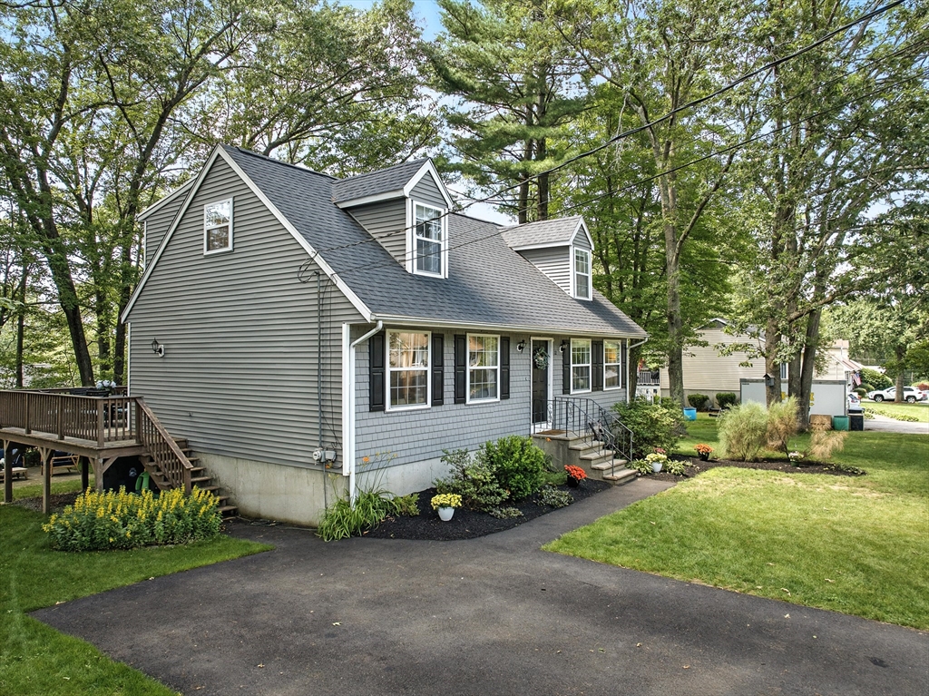 22 Dean Street Hudson, MA 01749 - Photo 3 of 30 a front view of a house with a garden and plants