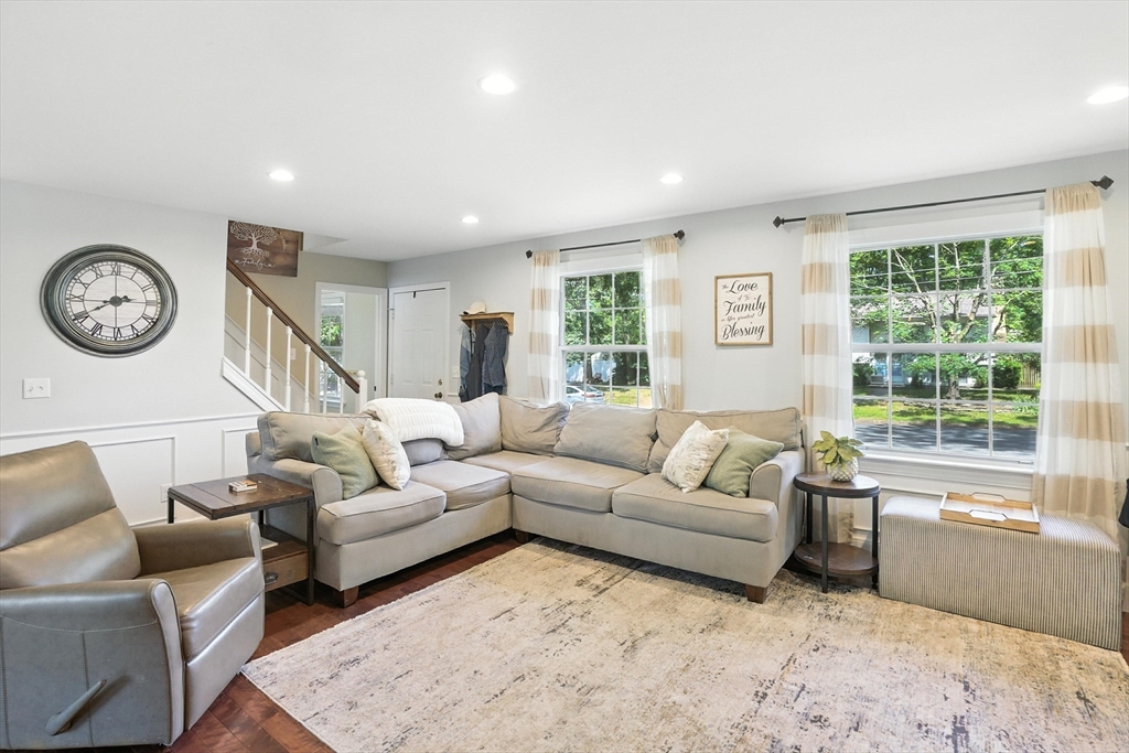 22 Dean Street Hudson, MA 01749 - Photo 6 of 30 a living room with furniture a large window and a clock
