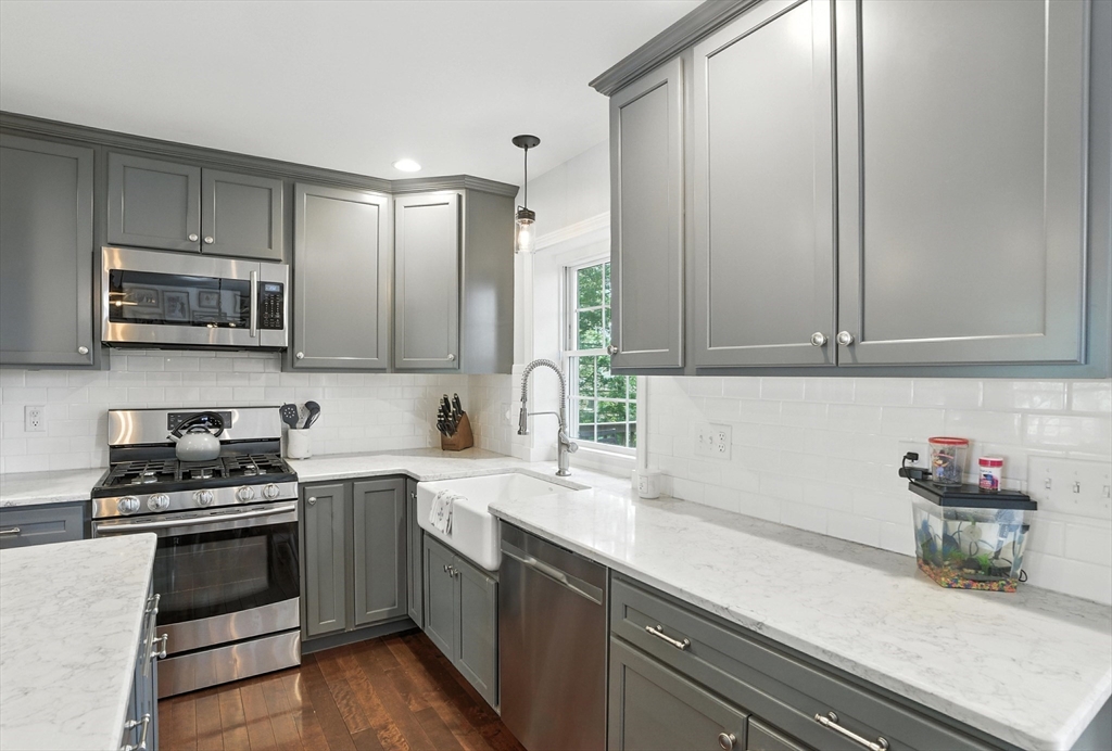 22 Dean Street Hudson, MA 01749 - Photo 9 of 30 a kitchen with stainless steel appliances a sink dishwasher stove microwave and cabinets
