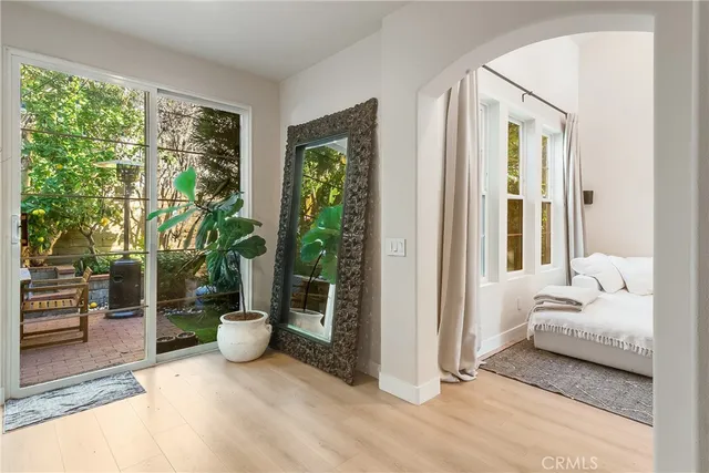 a bedroom with furniture and large windows