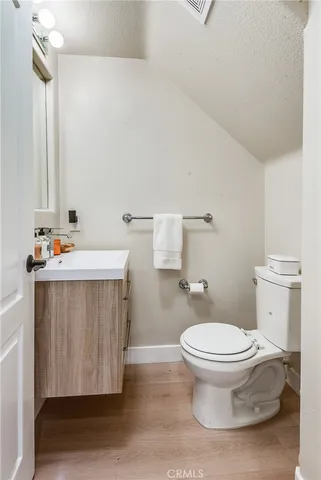 a bathroom with a sink toilet and a mirror