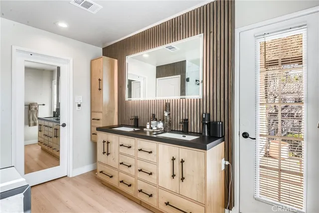 a bathroom with a sink a mirror and a shower
